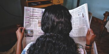 woman reading newspaper