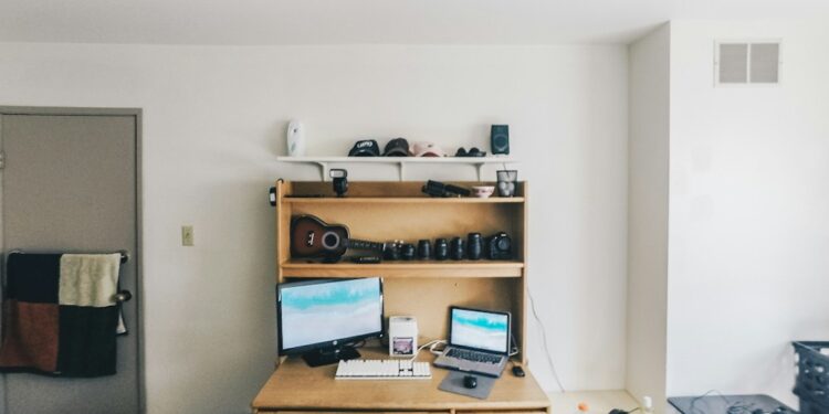 brown wooden desk with computer set