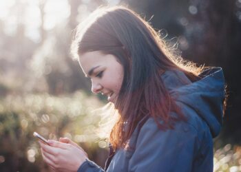 woman holding phone smiling