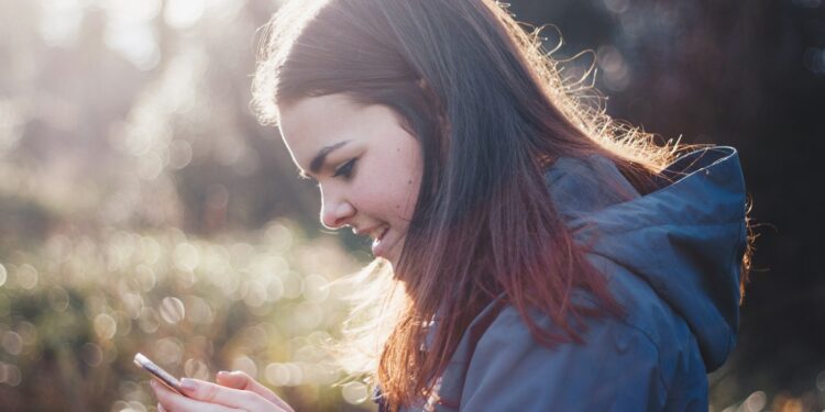woman holding phone smiling