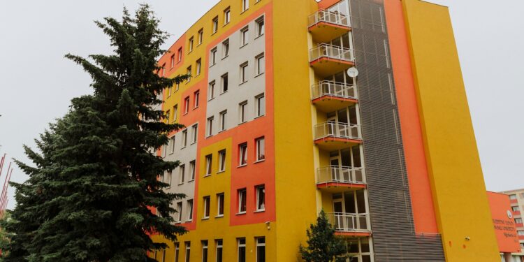 orange concrete building near green trees during daytime