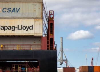 a large cargo ship sitting next to a dock