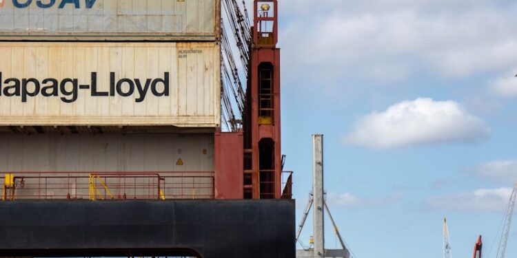 a large cargo ship sitting next to a dock