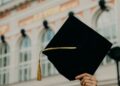 person holding black academic hat