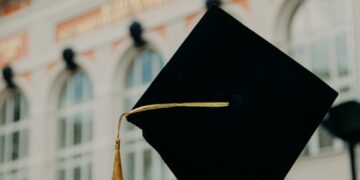 person holding black academic hat