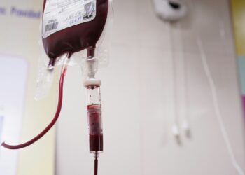 a blood test tube with a blood dropper attached to it