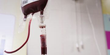 a blood test tube with a blood dropper attached to it