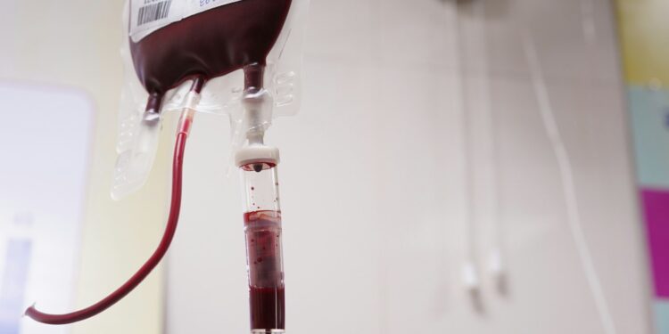 a blood test tube with a blood dropper attached to it